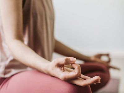 Close-up on hands in a meditative mudra position.